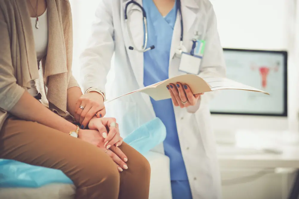 Doctor and patient discussing something while sitting at the table